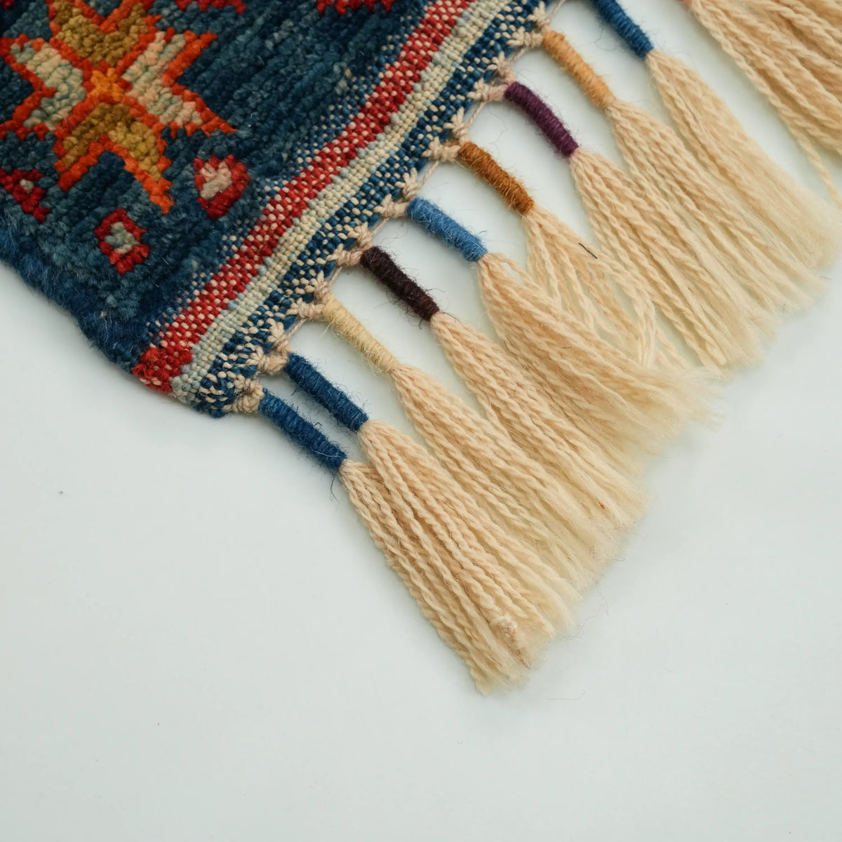 Anadolu Şal Series cream-field stripe-pattern rug — macro of the fringe; cream tassels, blue and burgundy wraps and the kilim band above