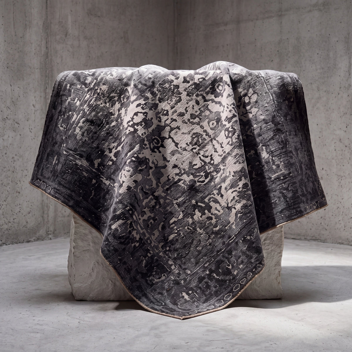 Ayan Series vintage-pattern rug — spread over a block in a concrete space, falling in folds