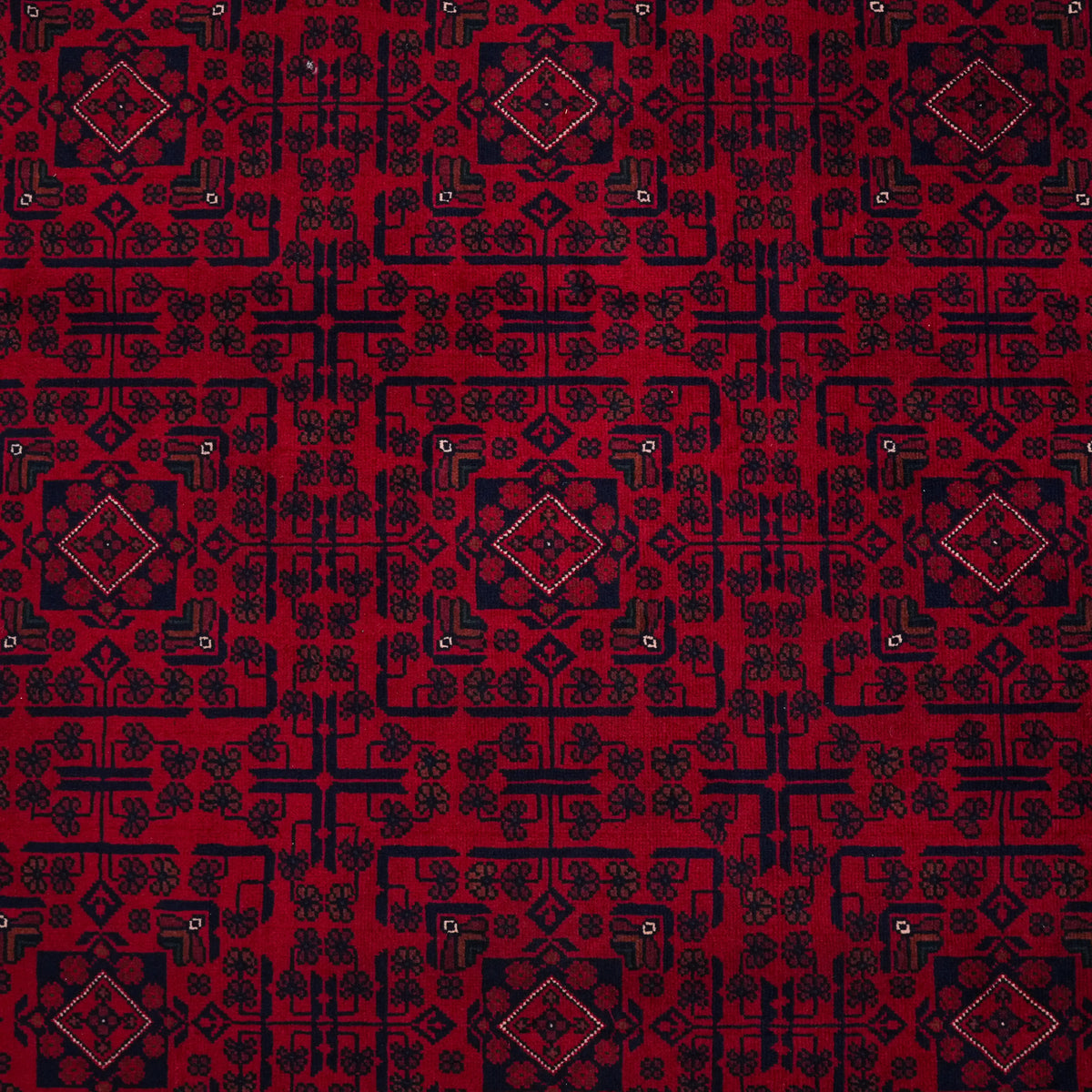 Burgundy ethnic-pattern rug — field from above; small medallions lined up inside a navy grid