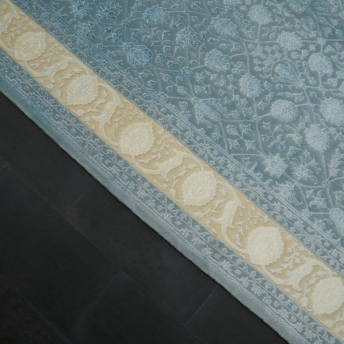 Safir Series blue floral rug — the cream border band running diagonally with the field on either side