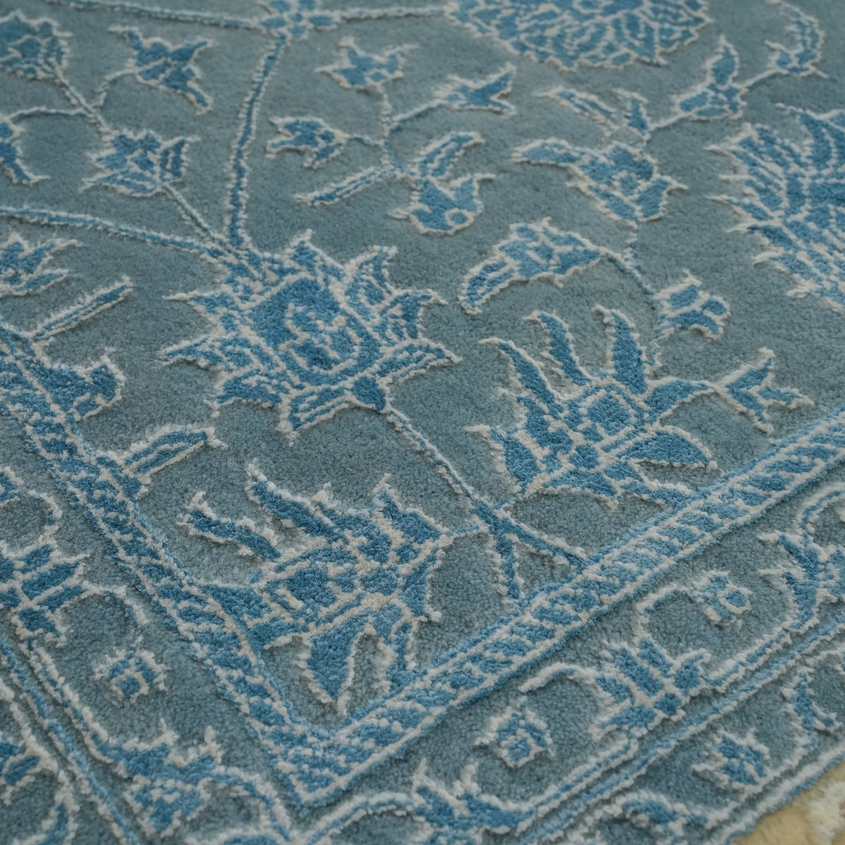 Safir Series blue floral rug — a close angled view of the raised blue flowers