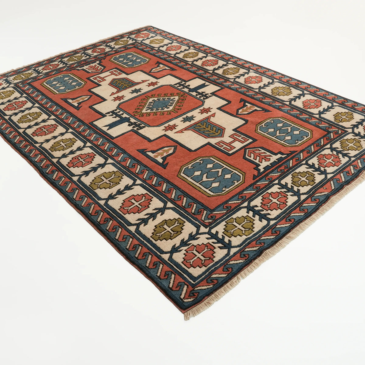 Multicolor Anatolian-pattern rug — the whole rug at an angle on a white backdrop; the medallions and the border bands enclosing them