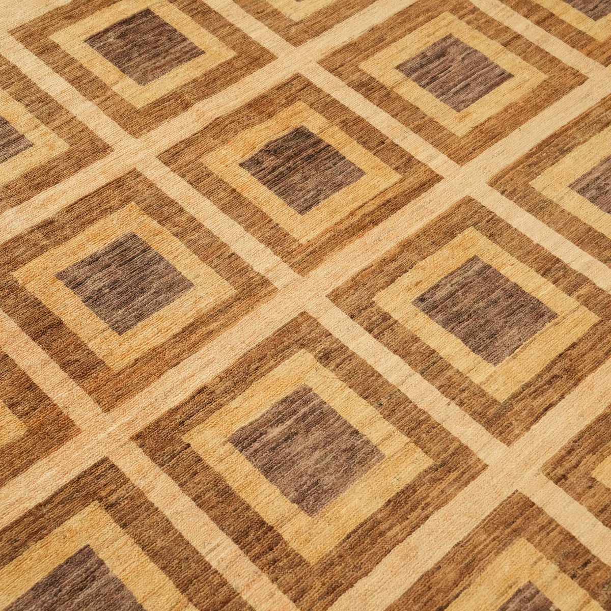 Mahal Series cream geometric rug — macro of the field, concentric squares with brown centers