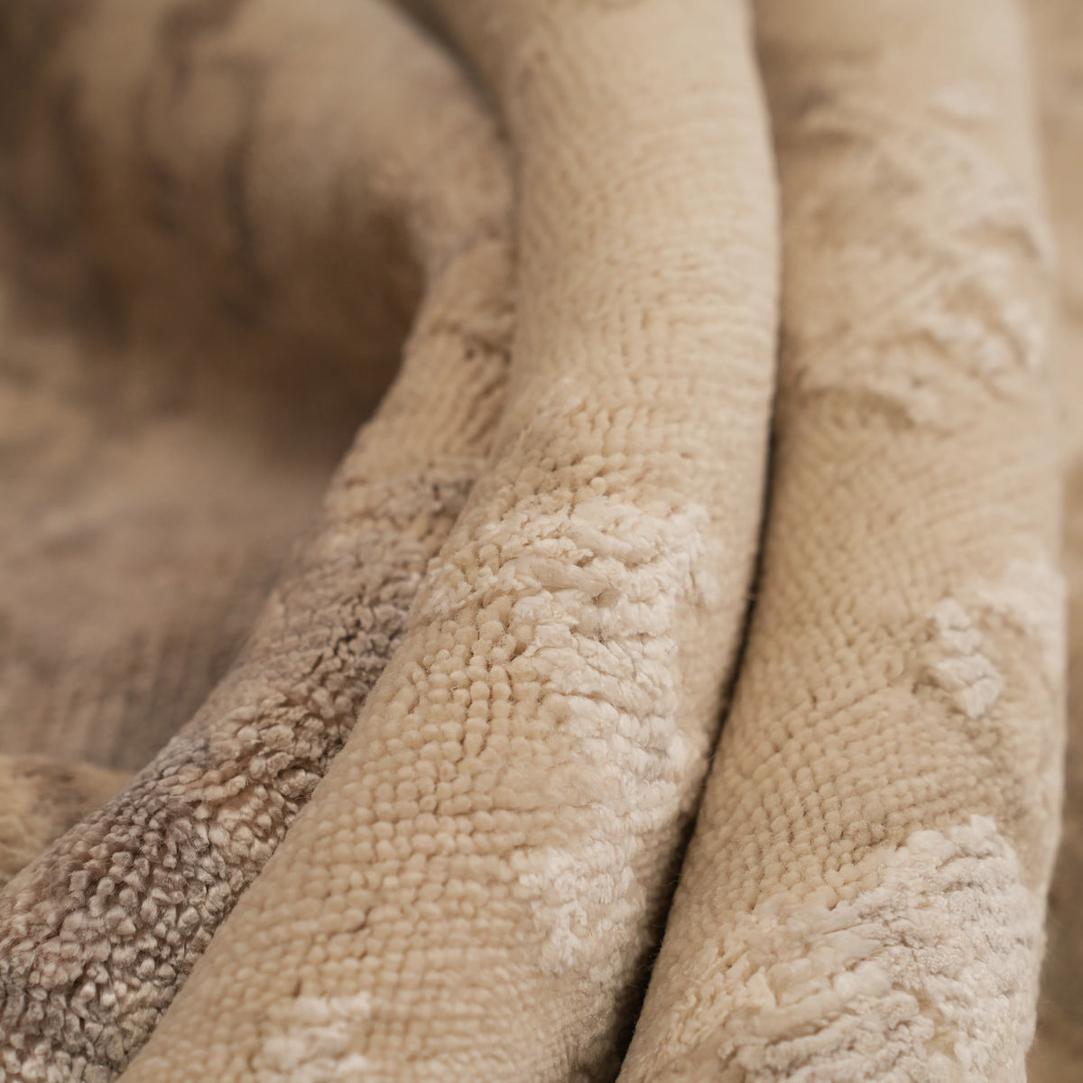 Maison Series cream abstract-pattern rug — macro, raised and short pile ridges in the folds