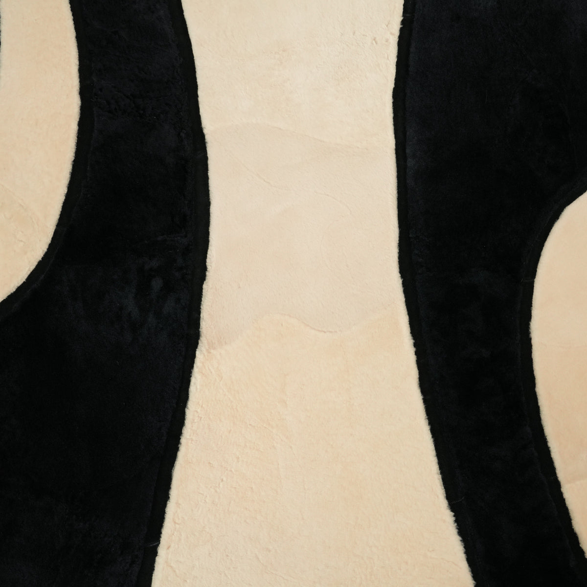 Black Curved-Band Sheepskin Rug — modern design