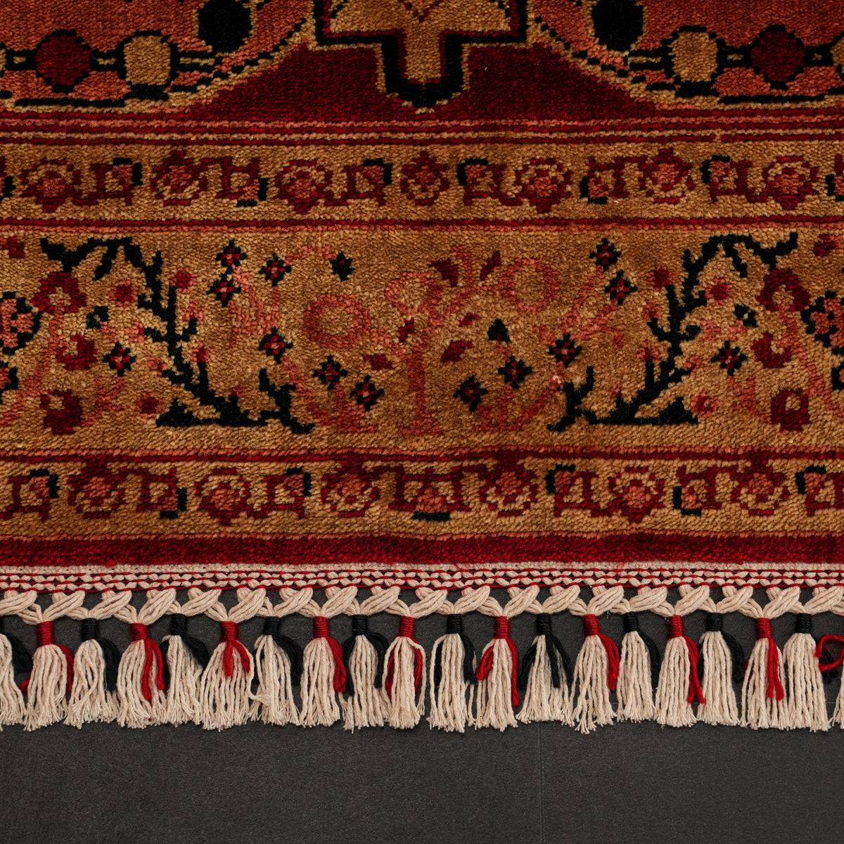Zade Series red rug — macro, border stripes and the line of tasseled fringe