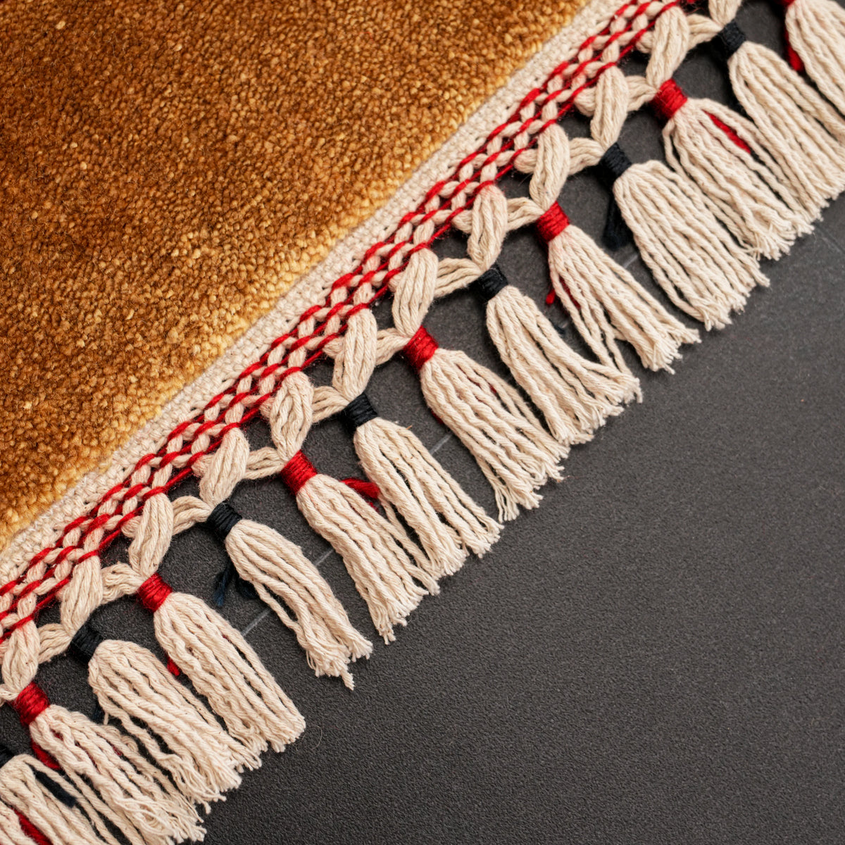 Zade Series medallion rug — fringe macro, red ties among cream tassels