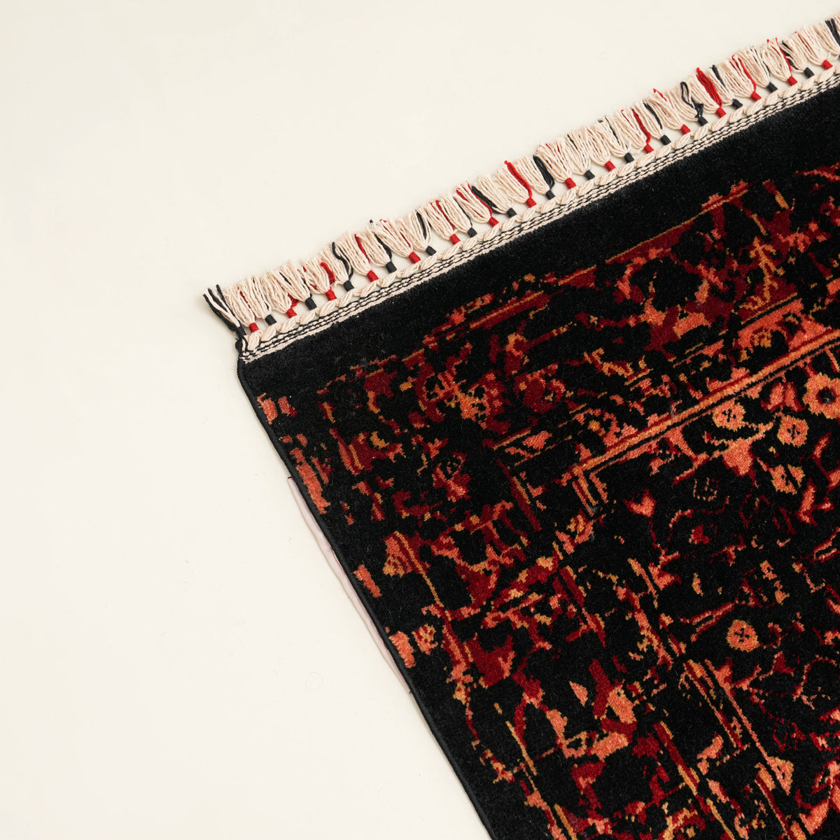 Zade Series vintage-patterned rug — corner on a white background, red-and-black wrapped fringe