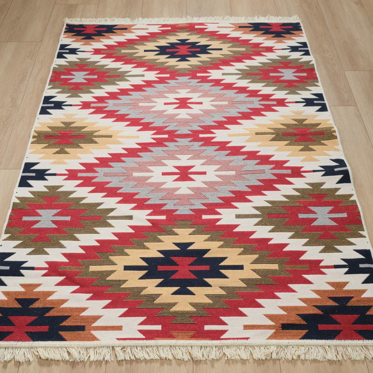 Kehribar Series multicolor Anatolian-pattern kilim — full view on wood; rows of red and navy diamonds