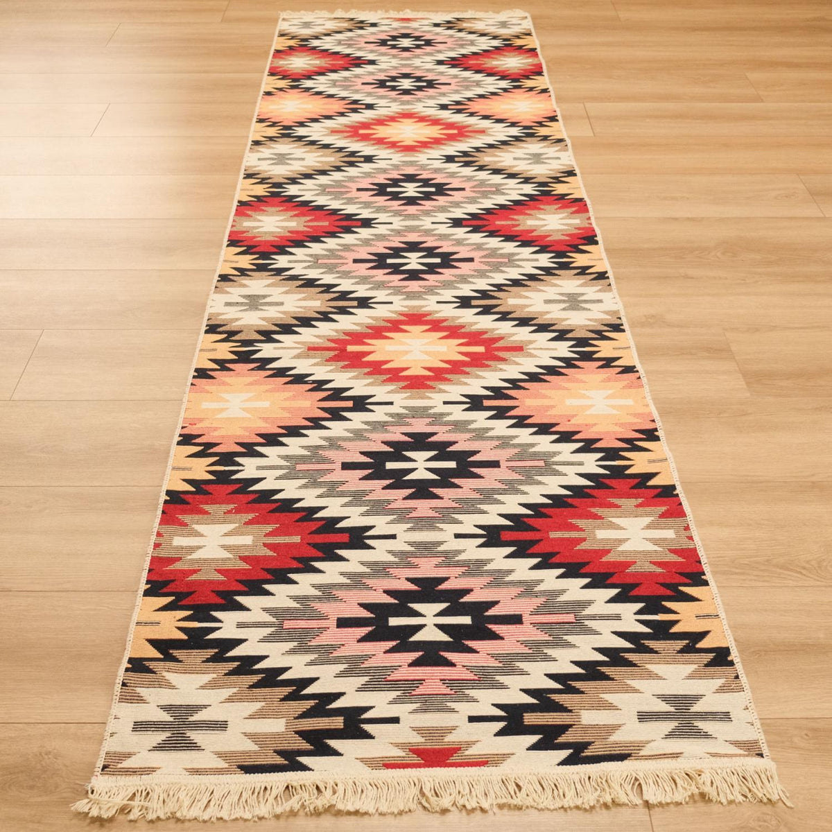 Kehribar Series multicolor Anatolian-pattern kilim — runner in perspective from the end on wood, cream fringe in front