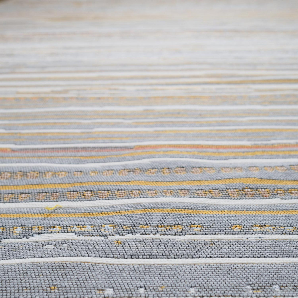 Kehribar Series multicolor striped kilim — faded cream area above, rough gray and mustard bands below