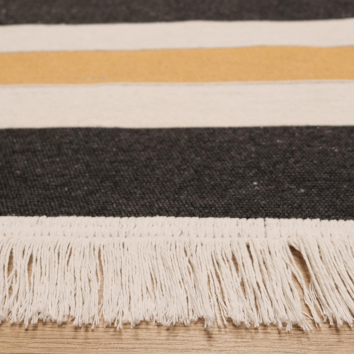 Kehribar Series gray striped kilim — close view of the fringed short end, cream tassels below the bands