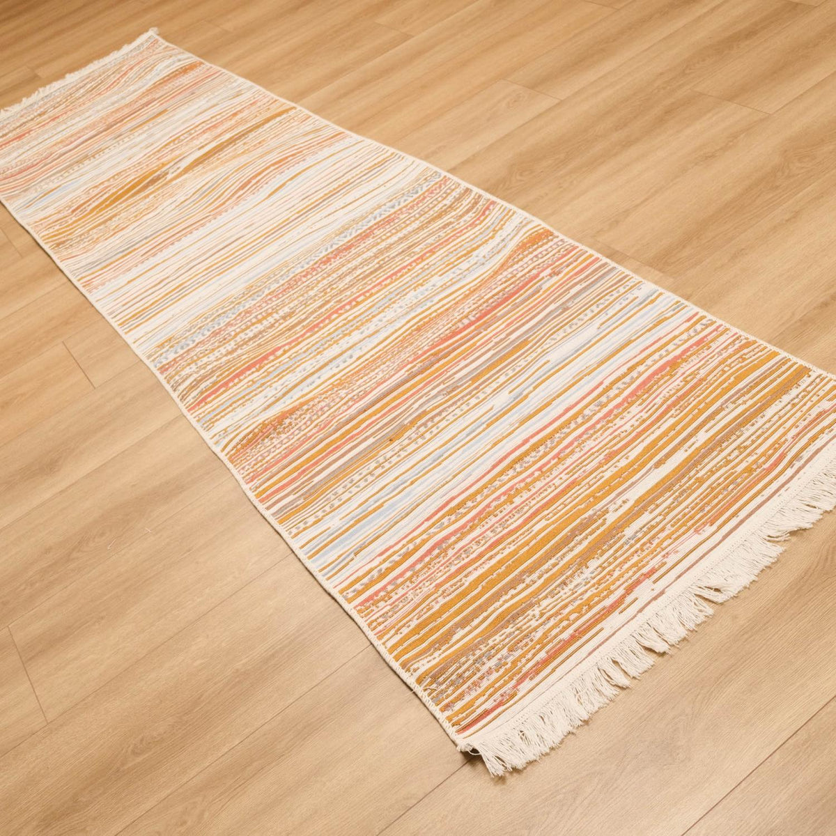 Kehribar Series multicolor striped kilim — runner cutting across the frame, orange and cream bands